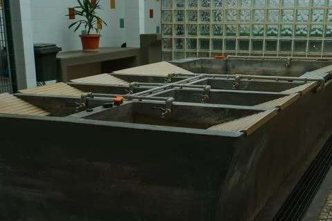 Old but functioning public laundry of an obsolete type in Lisbon. Dark gray.. Stock Photos