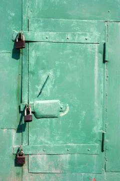 Old garage wicket with padlocks Stock Photos