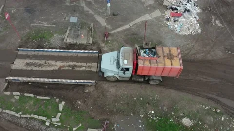 An old garbage truck pulls into a landfill for weighing control air view Video stock 157175780