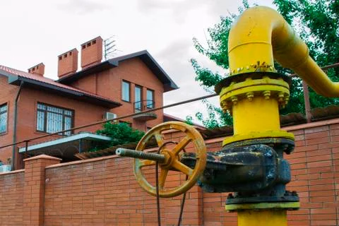 Old gas pipe gate on the background of the house Stock Photos