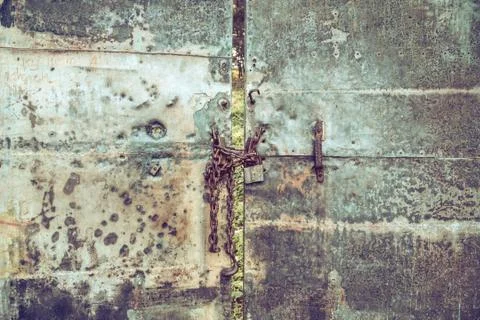 Old gate with a lock on the chain Stock Photos