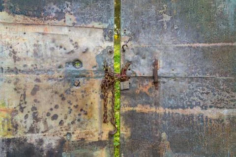Old gate with a lock on the chain Stock Photos