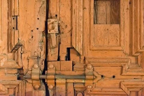 An old gate repaired makeshift with a lock Stock Photos