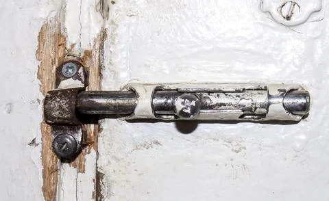 An old gate valve from the Soviet Union.An old Russian latch for the door. Stock Photos