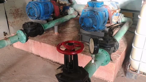 Old gate valves and electric pumps installed on the pipeline. Stock Footage 220143512