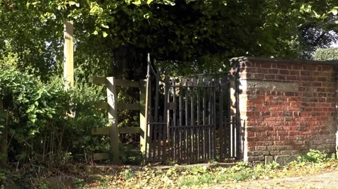 Old gate wall footpath moving trees countryside Stock Footage 57240380