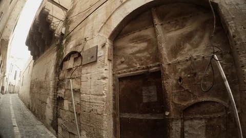 Old Gates and Doors Closed With Laying From Bricks Narrow Ancient Street in Stock Footage 75416159