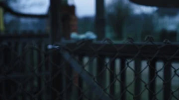 The old gates are swaying in the wind with an abandoned children's toy. Blurred Stock Footage 85746761