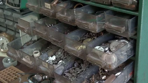 Old gears and vintage clock parts in watchmaker shop Stock Footage 77229776