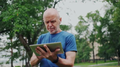 Old Gentleman Using Wireless Tablet PC. Retiree Learning New Internet Stock Footage 148316899