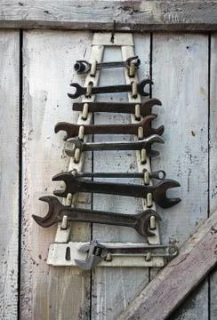 Old German and Soviet wrenches on a wooden wall Stock Photos