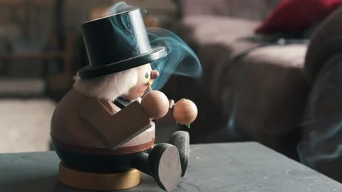 An old German smoking nutcracker antique with incense blowing from it's Stock Footage 181015492