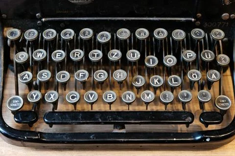 Old german typewriter keyboard with single letters and command keys Stock Photos