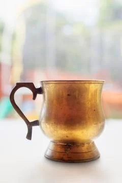 Old gilded copper pitcher Foto stock