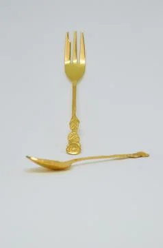 Old gilded spoon and fork Stock Photos