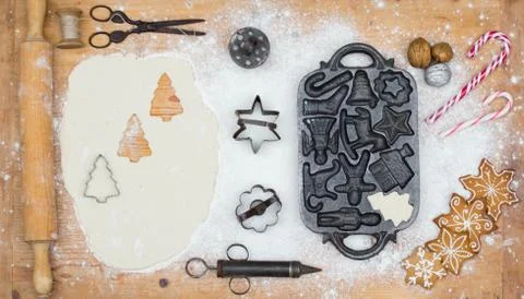 Old gingerbread maker baking sheet on wooden table with antiquities Stock Photos