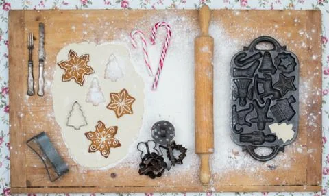 Old gingerbread maker baking sheet on wooden table with antiquities Stock Photos