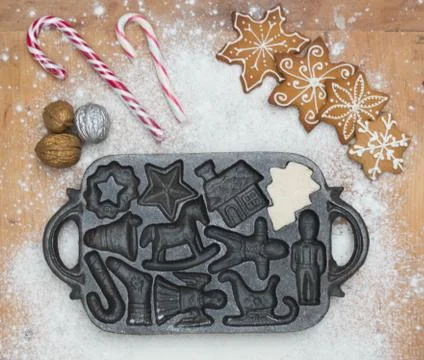 Old gingerbread maker baking sheet on wooden table with antiquities Stock Photos