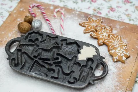 Old gingerbread maker baking sheet on wooden table with antiquities Stock Photos