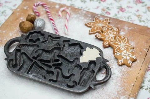 Old gingerbread maker baking sheet on wooden table with antiquities Foto stock
