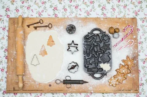 Old gingerbread maker baking sheet on wooden table with antiquities Stock Photos