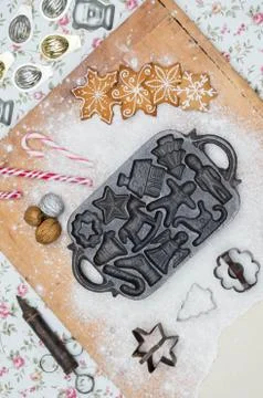 Old gingerbread maker baking sheet on wooden table with antiquities Stock Photos