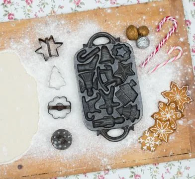 Old gingerbread maker baking sheet on wooden table with antiquities Stock Photos