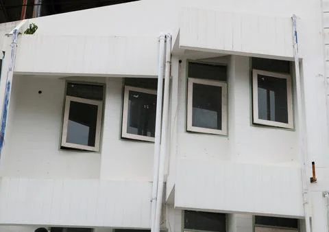 Old glass window and tint of white building. Stock Photos