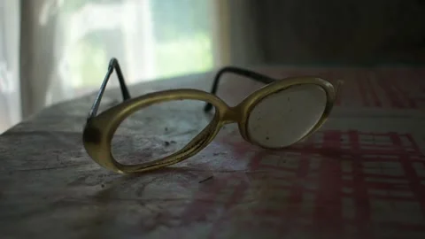 Old glasses with one lens on the table Stock Footage 135412707