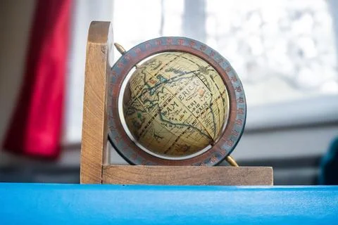 Old globe on the blue book. Abstract concept: planning travel, adventures. Stock Photos