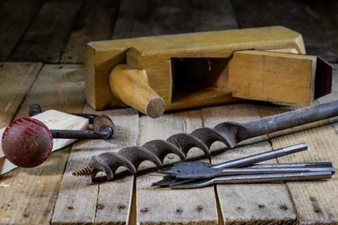 Old good carpentry, tools drill bit. Wooden carpentry table and old good carp Stock Photos