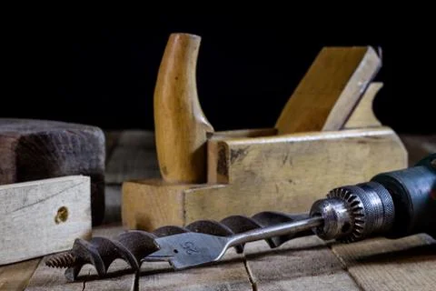 Old good carpentry, tools drill bit. Wooden carpentry table and old good carp Stock Photos