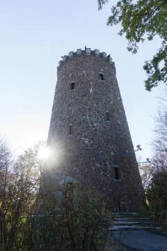 Old gothic castle tower backlight sunny day in park Stock Photos