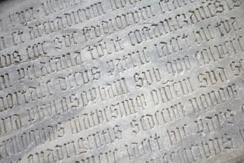 Old gothic text in Parma cathedral wall in Italy Stock Photos