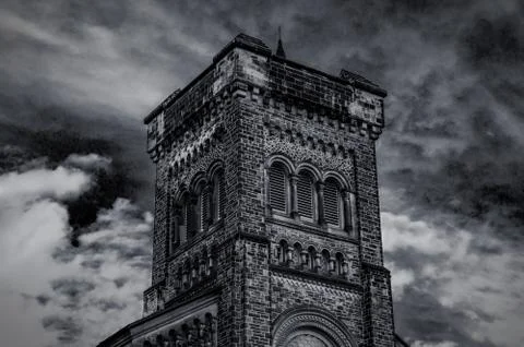 Old gothic tower in front of cloudy blue sky 스톡 사진