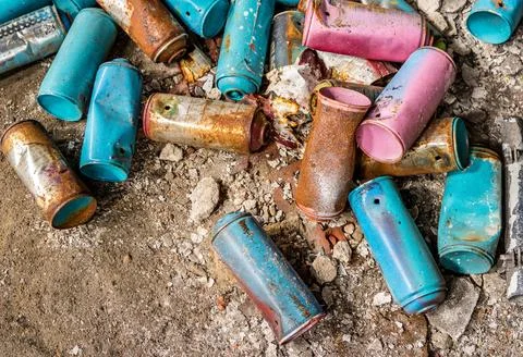 Old Graffiti Spray Paint Cans with Worn Labels and Urban Street Art Style Stock Photos