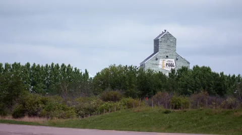 Old grain elevator with truck driving by Stock Footage 67296066