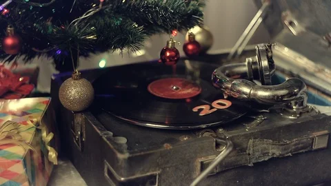An old gramophone playing under a decorated Christmas tree Stock Footage 96008194