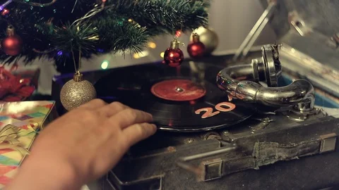 An old gramophone playing under a decorated Christmas tree Stock Footage 96329698