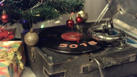 An old gramophone playing under a decorated Christmas tree Stock Footage 112352402