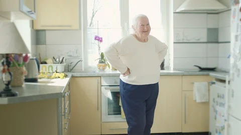 Old Grandmother Dancing In The Kitchen. Stock Footage 128829595