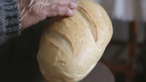 Old grandmother stroked bread Stock Footage 76355059