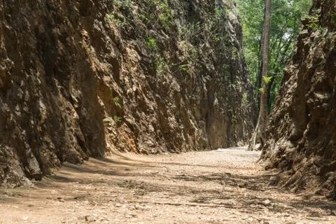 Old gravel path through the Hellfire Pass memorial in Kanchanaburi, Thailand. Stock Photos