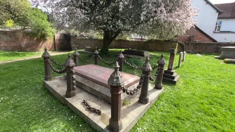 Old Gravestone and Blossoming Tree in UK Graveyard – Gimbal hot Stock Footage 332814322