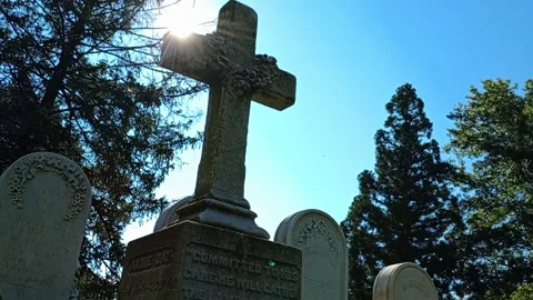 Old Gravestone Partial Silhouette With Sunlight and Sun Beam Life and Death Stock Footage 282193216