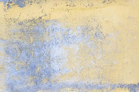 Old gray blue wall texture with peeling yellow paint background. Closeup. Stock Photos