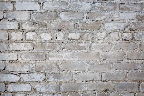 Old gray brick wall background or texture, close up. Stock Photos