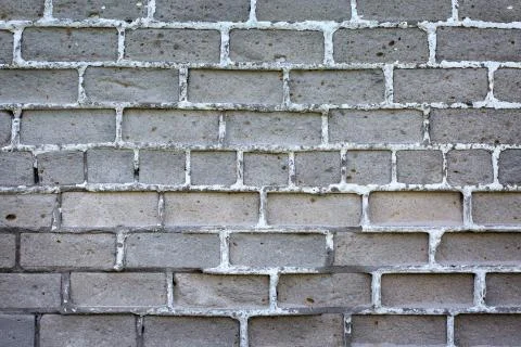 Old gray brick wall background or texture, close up. Stock Photos
