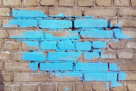 Old gray brick wall with a big spot of blue paint, texture, background Stock Photos