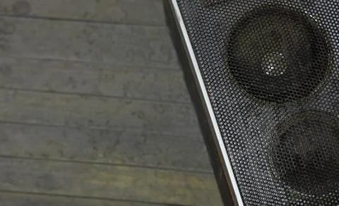 Old gray speaker on a gray background. Stock Photos